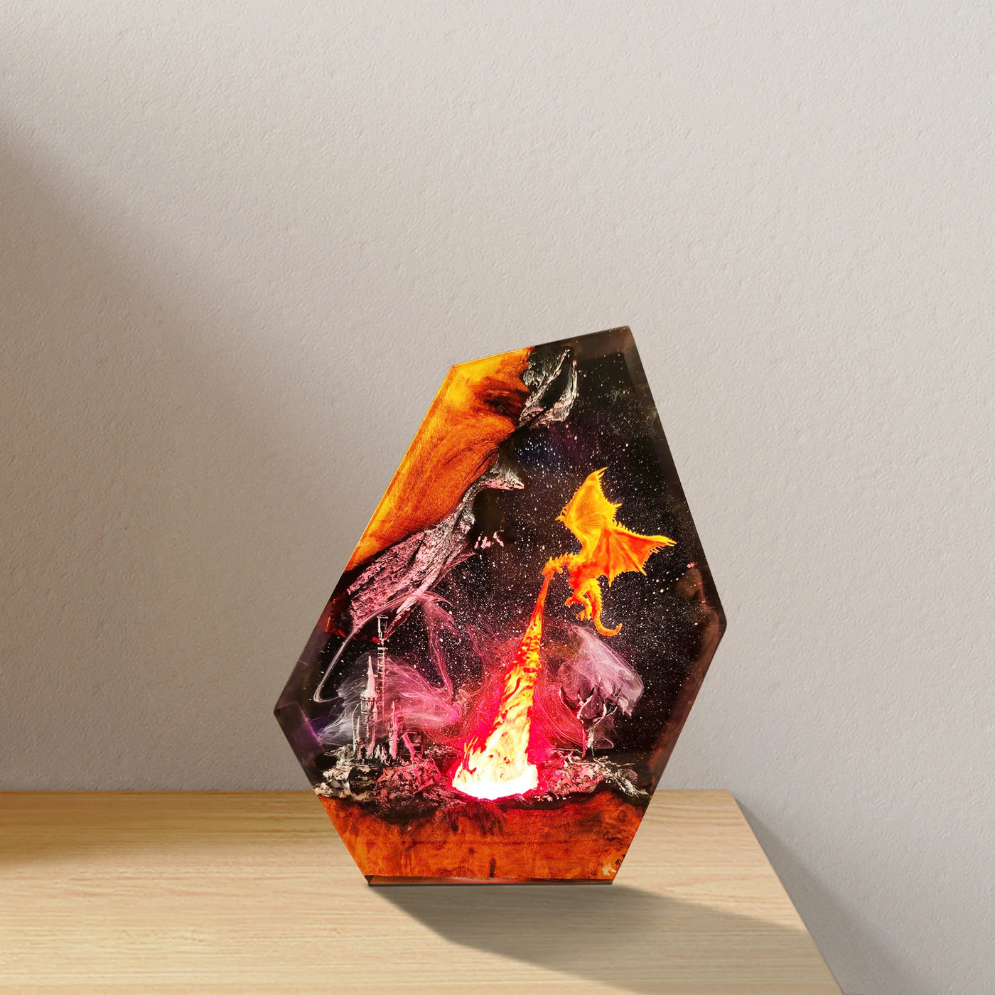 Close view of fire dragon circling a burning citadel inside resin with hand-finished texture and molten orange and violet light