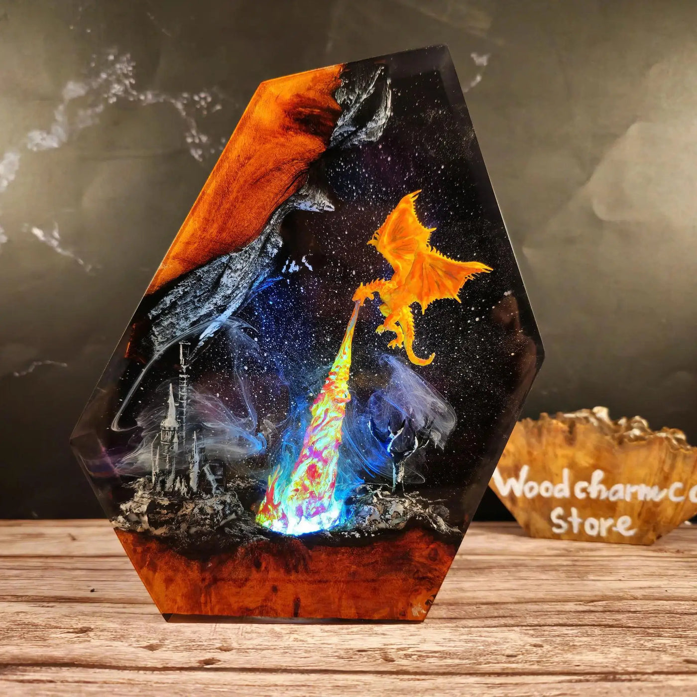 Angled view of fire dragon circling a burning citadel inside resin with layered depth and molten orange and violet light