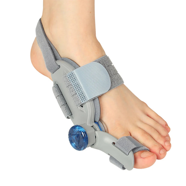 Gray adjustable bunion corrector fitted around the foot and big toe