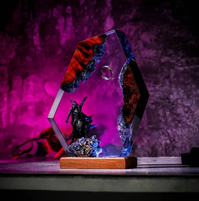 Side view of armored shadow sovereign beneath a suspended ring in resin showing clear sculptural depth and illuminated detail